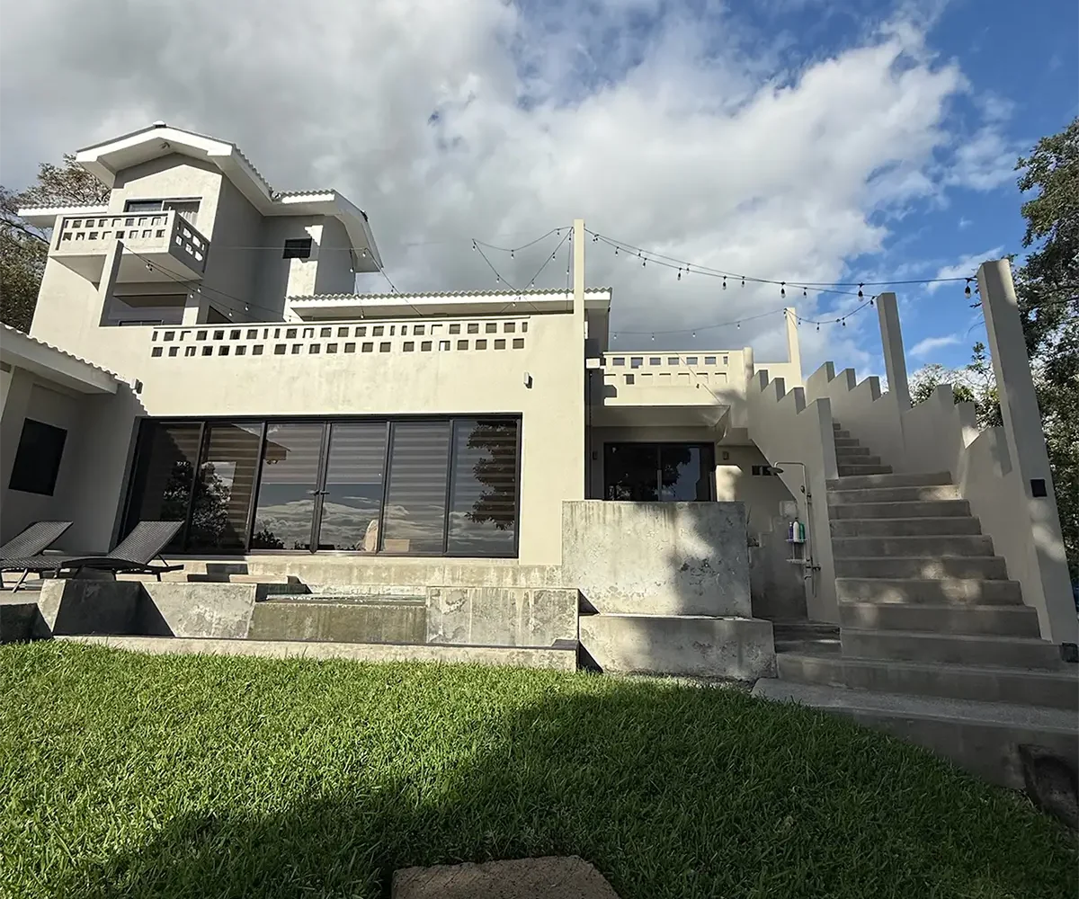 Three-story exterior and lawn of Casa Cerca del Cielo in Rancho Santana